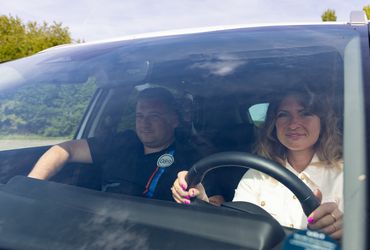 Fahrlehrer und Fahrschülerin im Fahrschulwagen